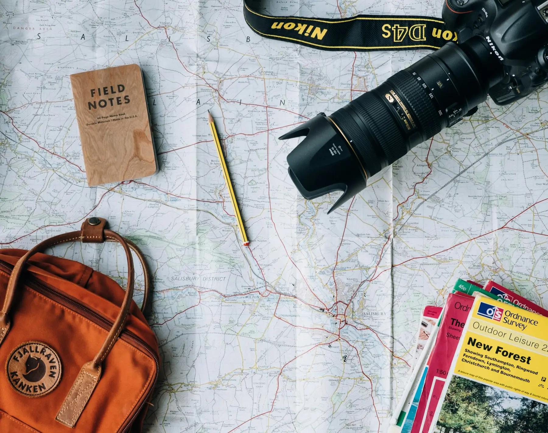 Carte, carnet de notes et appareil photo pour préparer un voyage